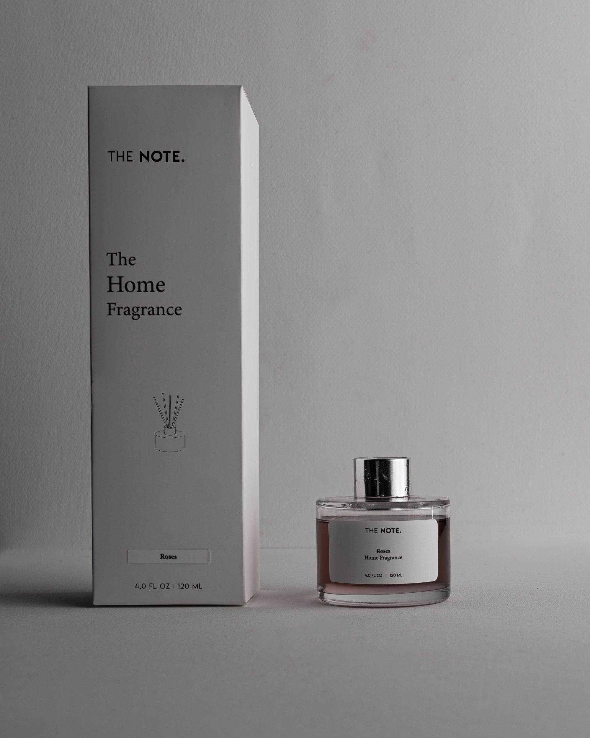 Home fragrance bottle and packaging with 'The Note' branding on a gray background