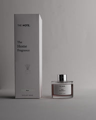 Home fragrance bottle and packaging with 'The Note' branding on a gray background